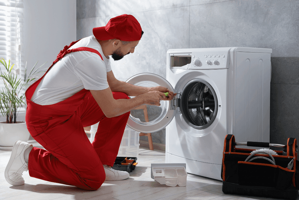 Certified washing machine repair technician in Dubai fixing a front-load washer